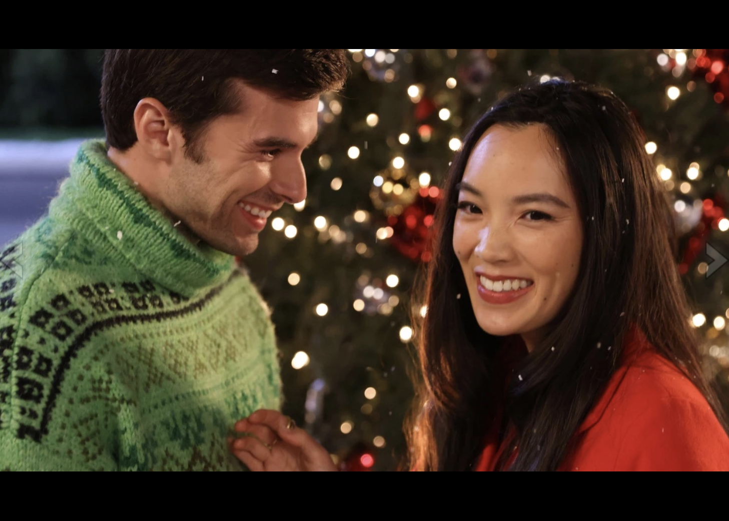Main characters in a romantic Christmas moment